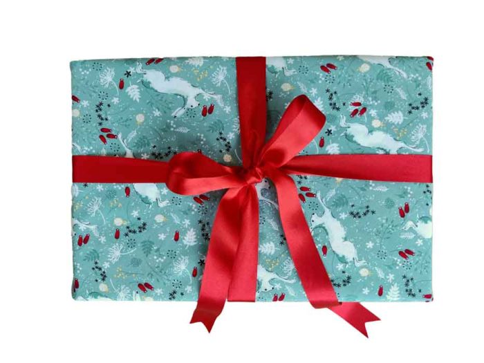 Christmas Present in Fabric Wrapping. White Hares on Sage Cotton Design and Red Ribbon