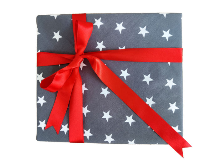 Large present wrapped in Deep Grey and White Star cotton with red satin Ribbon